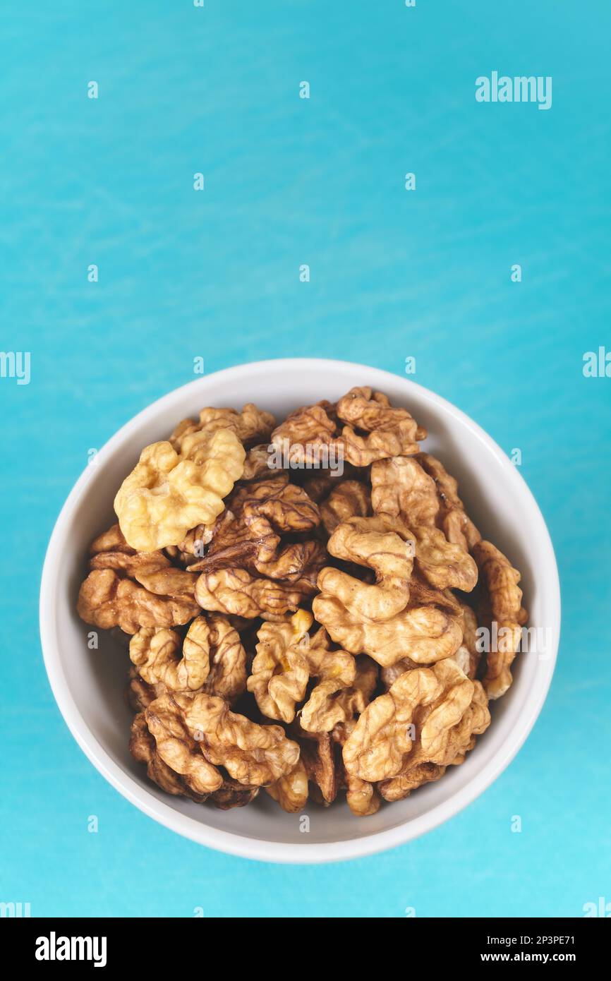 Organic walnuts in a bowl, selective focus. Stock Photo