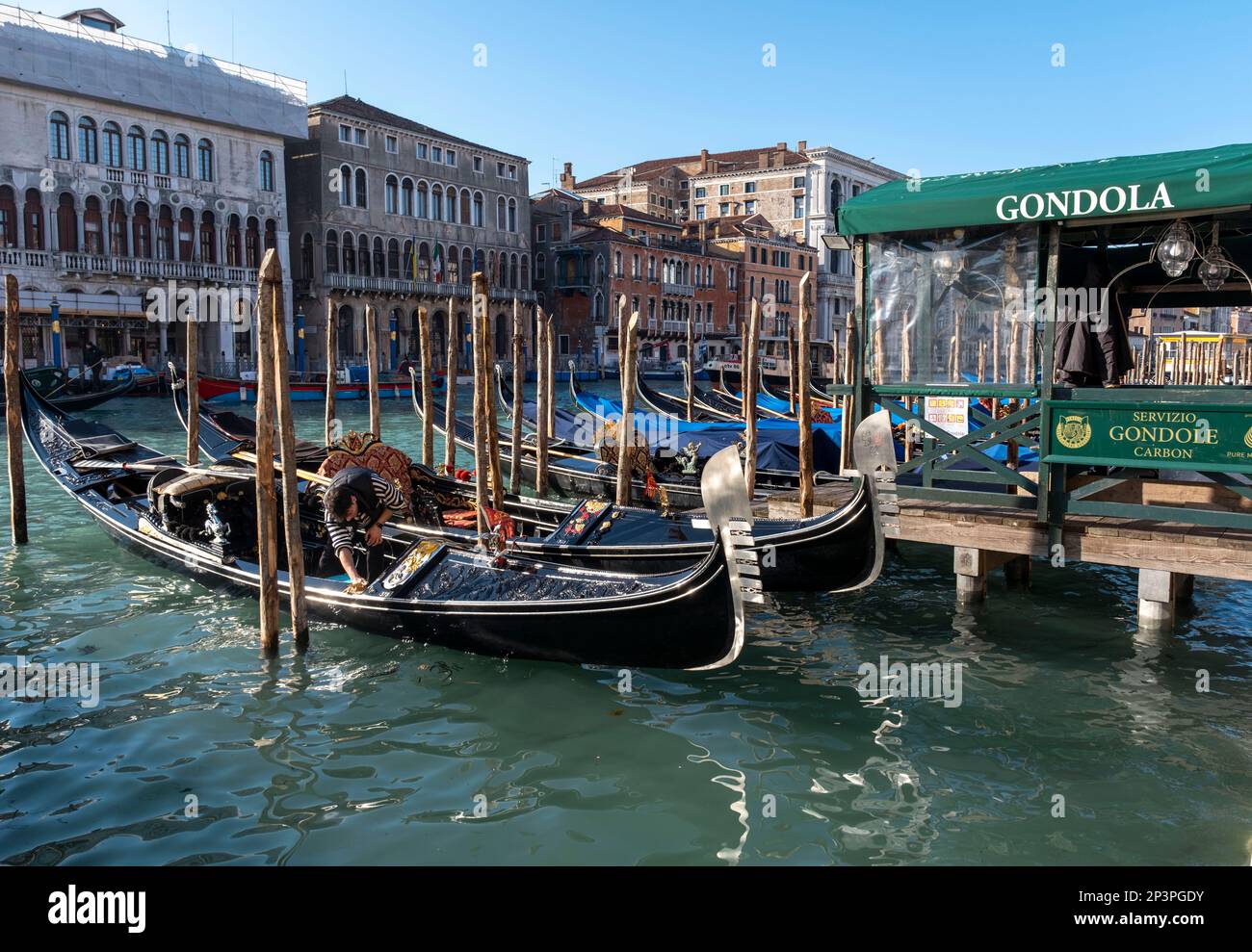 Gondolas tied up at a Gondola Station, on the Grand Canal at San Silvestro, Rialto, Venice, Italy Stock Photo