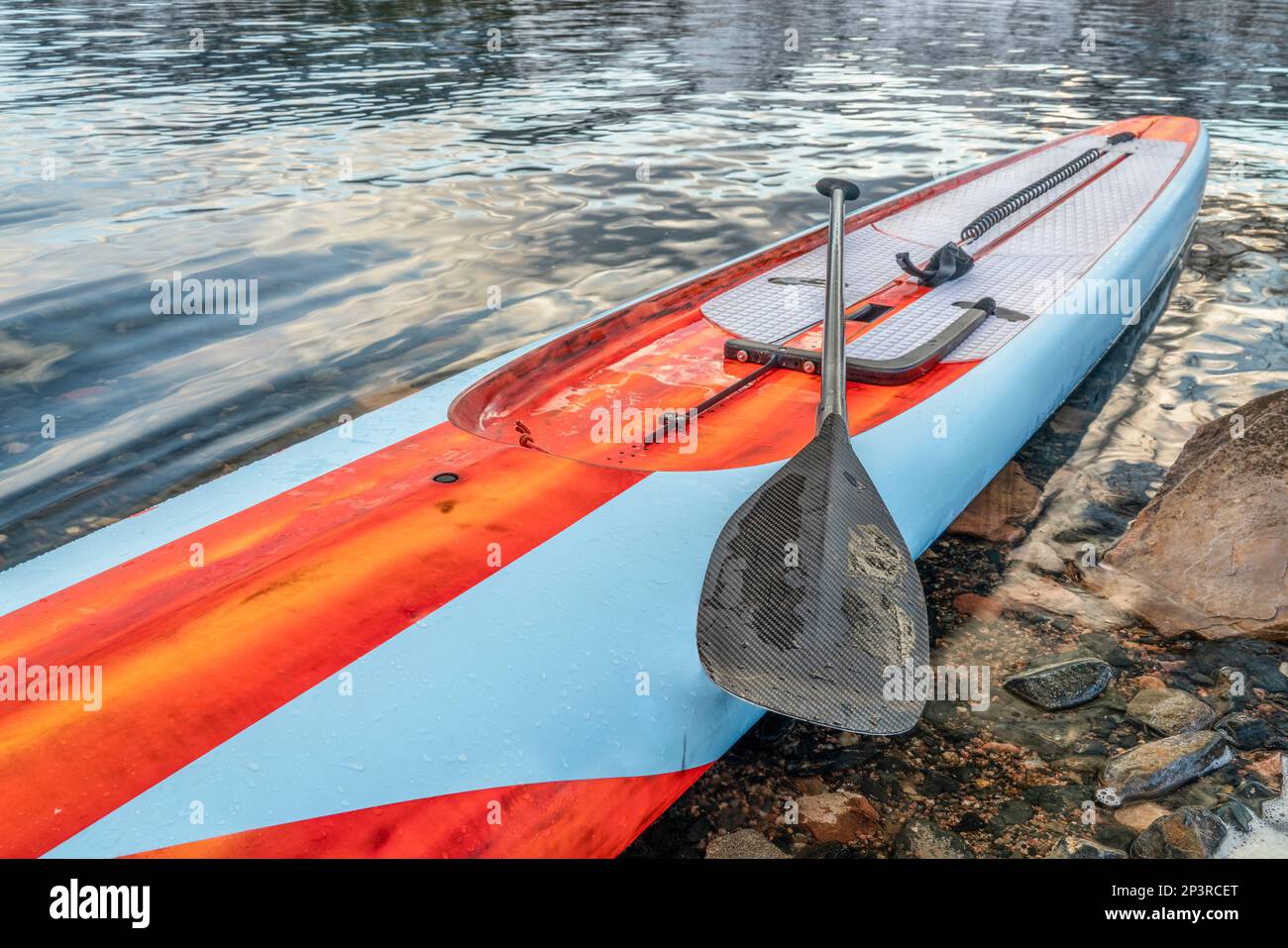 racing stand up paddleboard with paddle, safety leash and steering