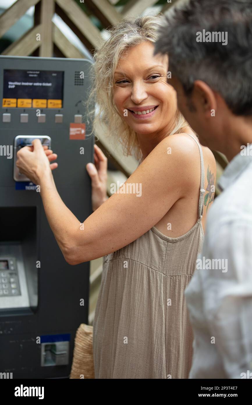 woman paying at ticket machine in a metro station Stock Photo