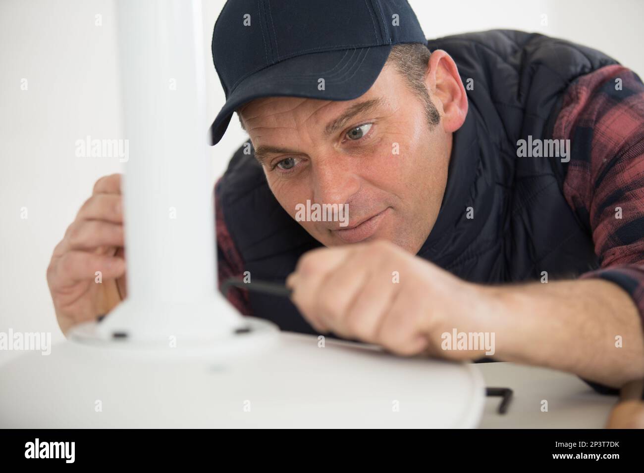 concentrated man in fixing a chair Stock Photo Alamy