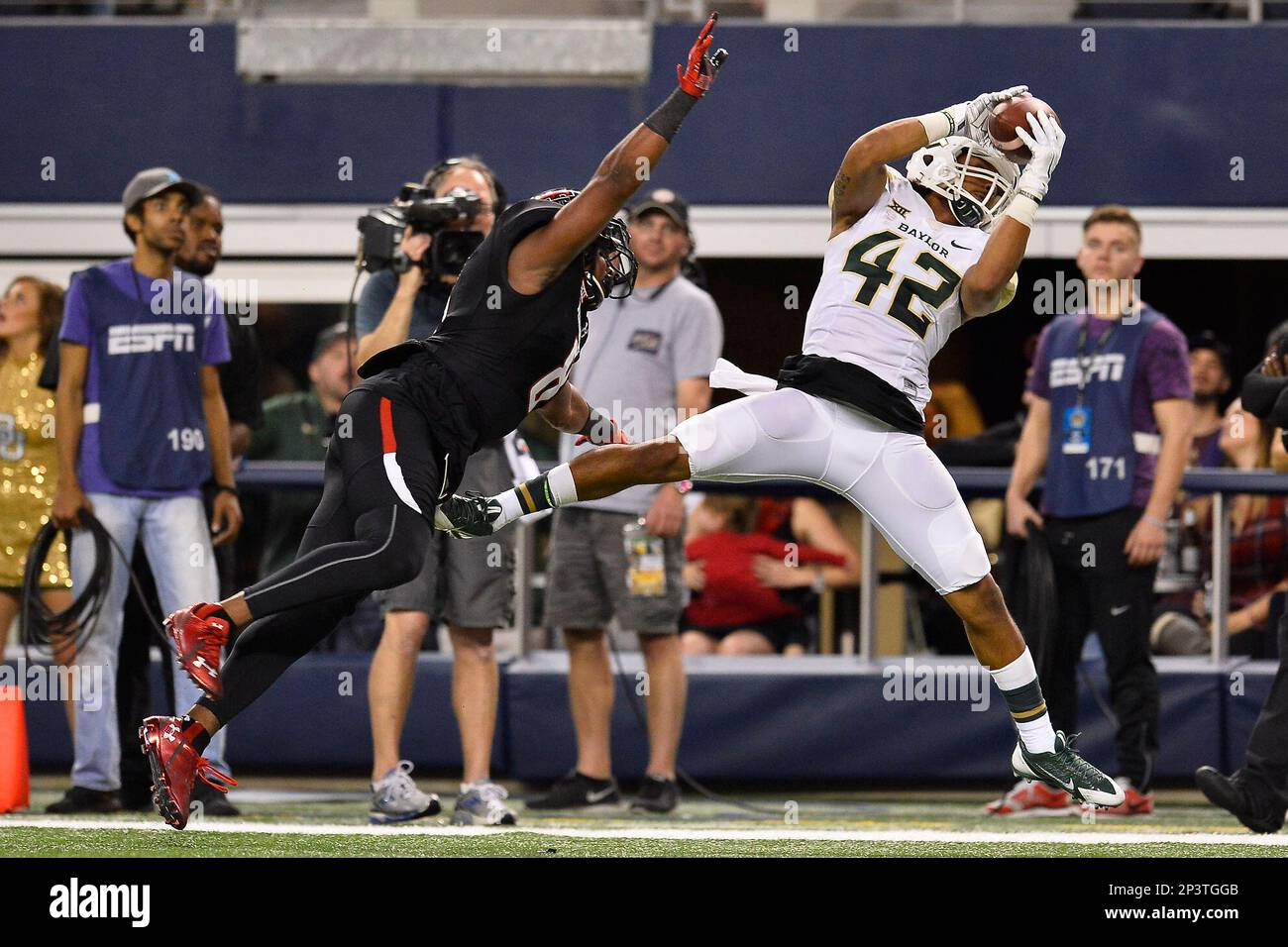 Baylor inside receiver Levi Norwood (42) catches a pass while defended by  Texas Tech defensive back Austin Stewart (8) during an NCAA Football game,  Saturday, November 29, 2014 in Arlington, Tex. Baylor