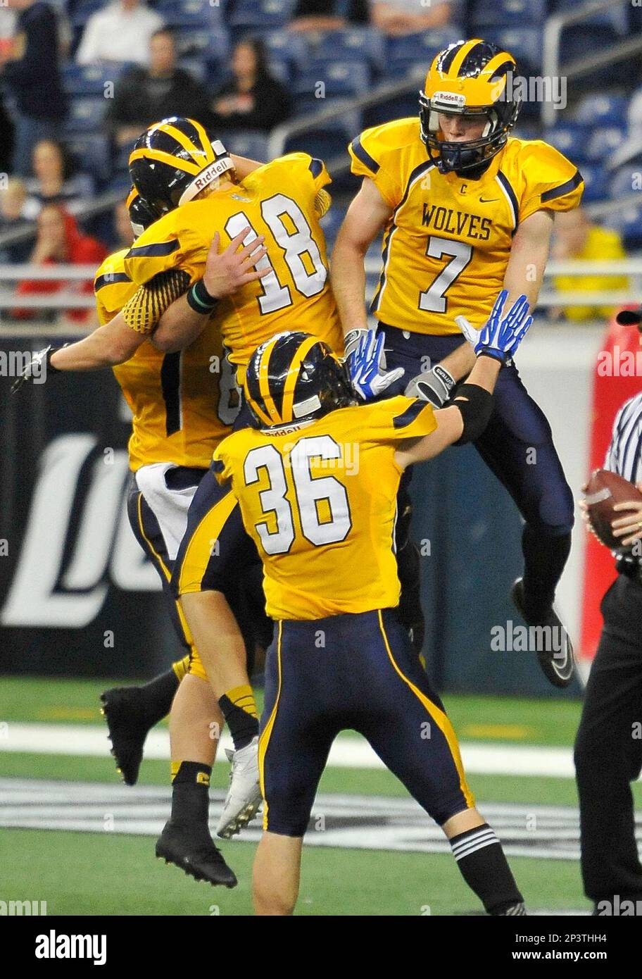 Clarkston s Merrick Canada Austin Egler and Nolan Eriksen celebrate Canada s touchdown in the third quarter of the MHSAA Division 1 Championship high school football game Saturday Nov. 29 2014 in Detr...