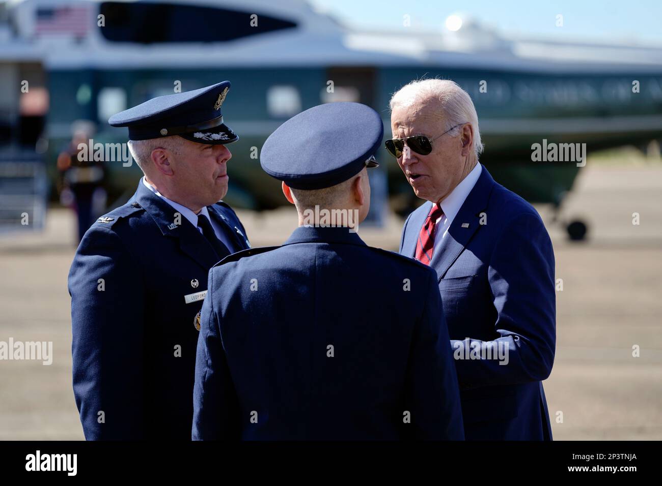 President Joe Biden talks with Maj. Gen. William Holt II, center, and
