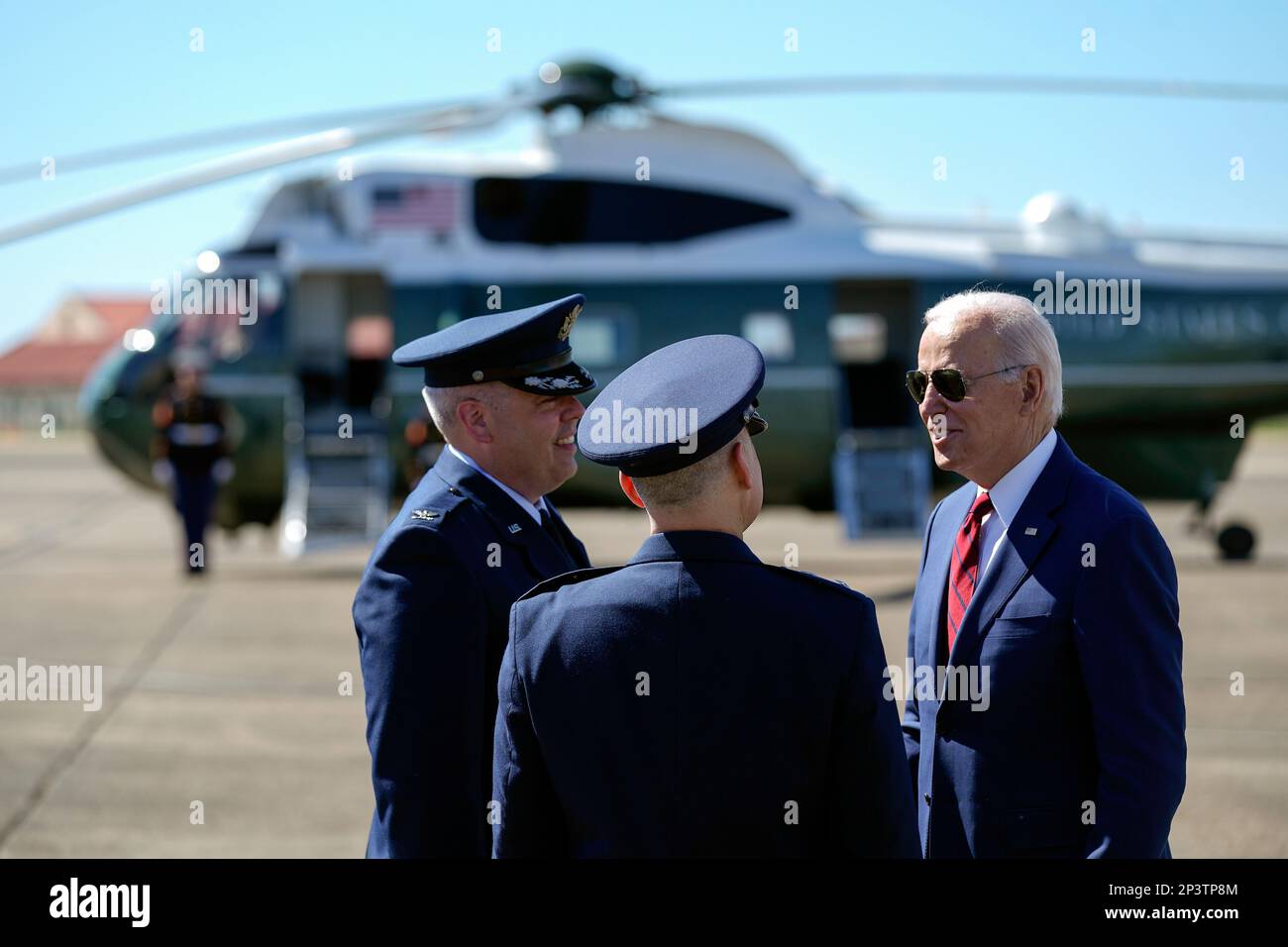 President Joe Biden talks with Maj. Gen. William Holt II, center, and