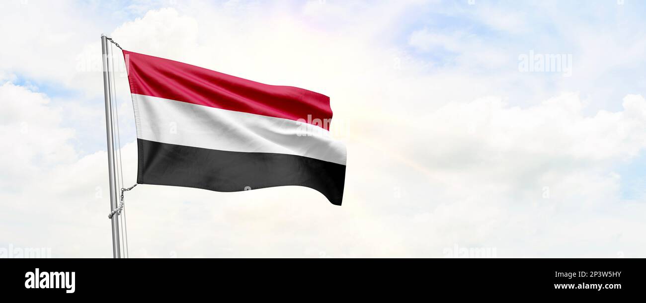 Yemen flag waving on sky background. 3D Rendering Stock Photo - Alamy