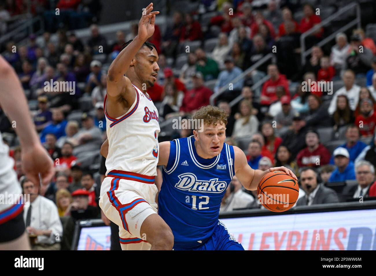 Drake guard Tucker DeVries (12) drives to the net as Bradley guard Zek