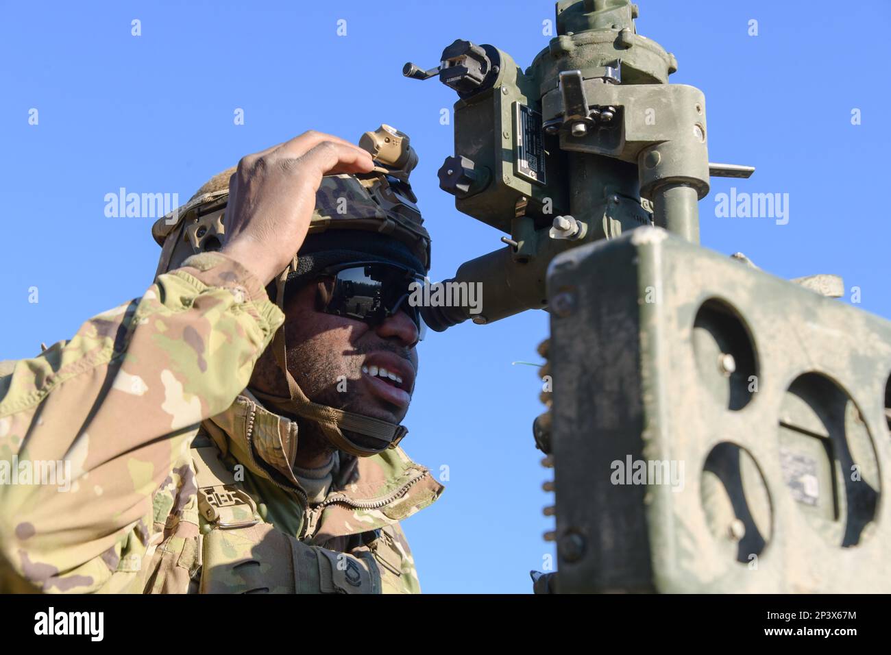 A U.S. Soldier assigned to Field Artillery Squadron, 2nd Cavalry Regiment aligns a M777 155mm howitzer to a targets coordinates during Table XVIII certifications as part of Dragoon Ready 23 exercise at the 7th Army Training Command’s Grafenwoehr Training Area, Germany, February 9, 2023. Dragoon Ready 23 is designed to ensure readiness and train the regiment in its mission-essential tasks in support of unified land operations to enhance proficiency and improve interoperability with NATO Allies. Stock Photo
