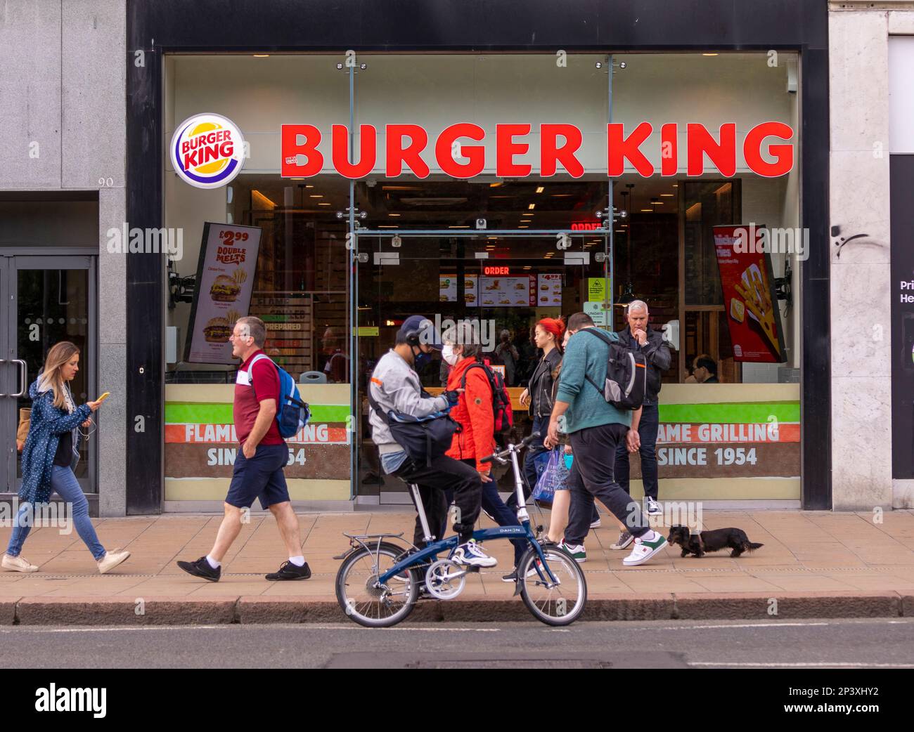 EDINBURGH, SCOTLAND, EUROPE - People on sidewalk in front of Burger King Restaurant. Stock Photo