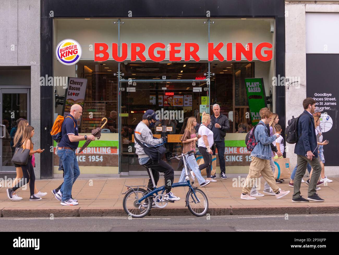 EDINBURGH, SCOTLAND, EUROPE - People on sidewalk in front of Burger King Restaurant. Stock Photo