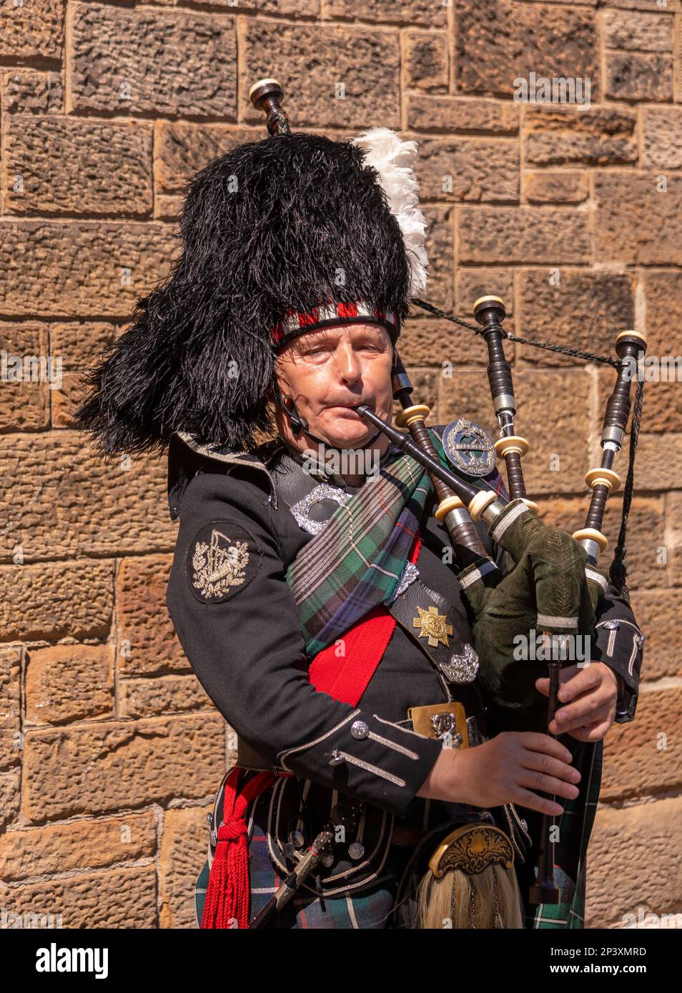 EDINBURGH, SCOTLAND, EUROPE - Man plays bagpipes on Royal Mile. Stock Photo