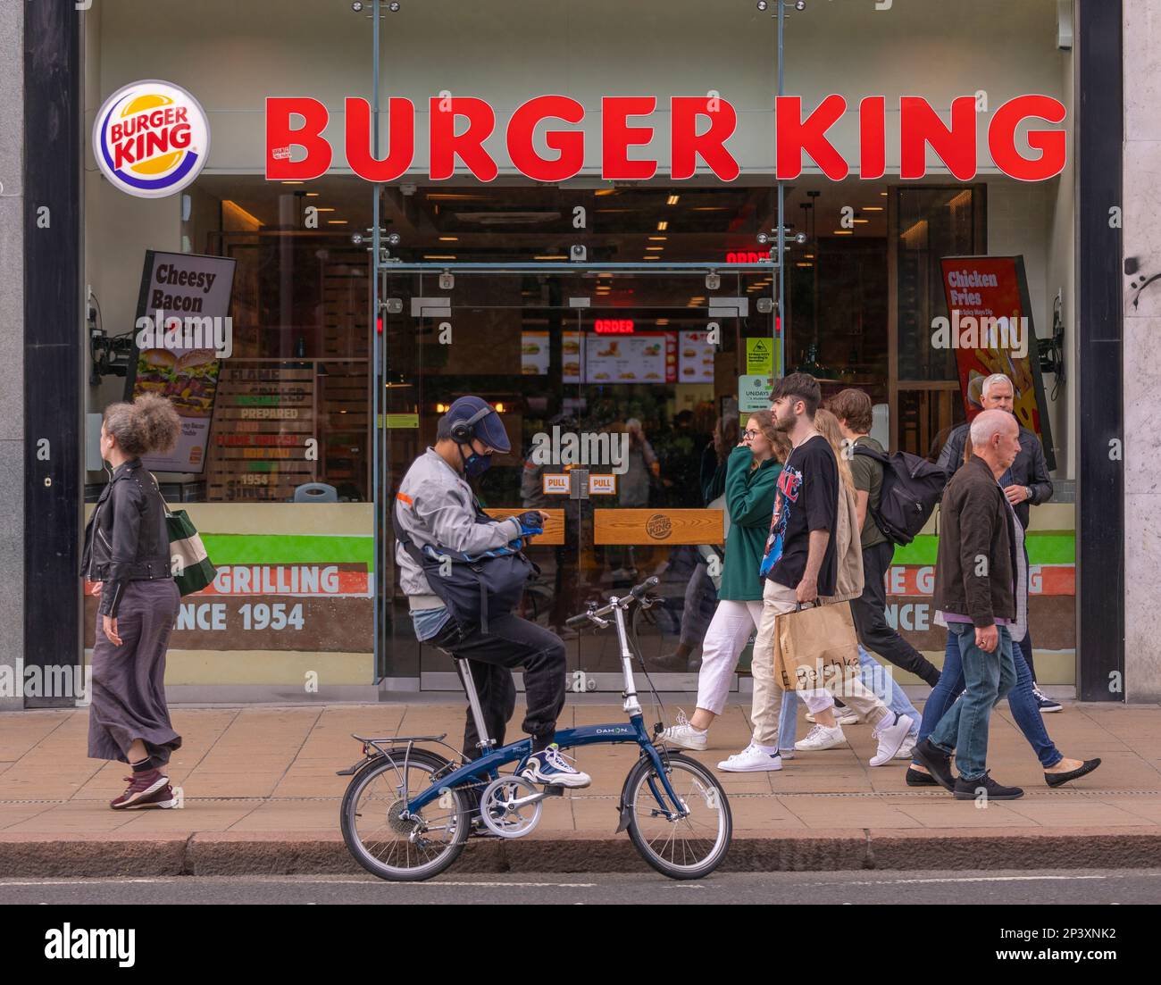 EDINBURGH, SCOTLAND, EUROPE - People on sidewalk in front of Burger King Restaurant. Stock Photo