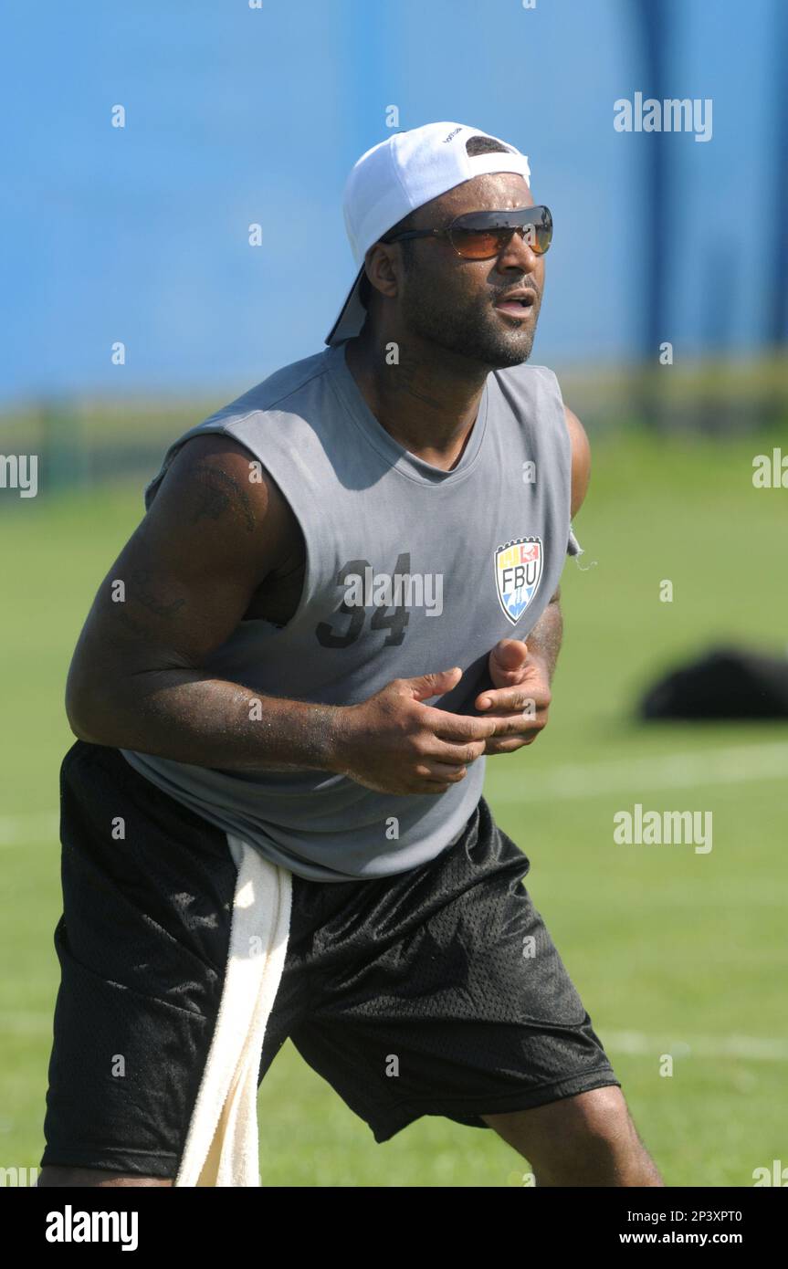 Former NFL receiver Andre Rison instructs high school football players