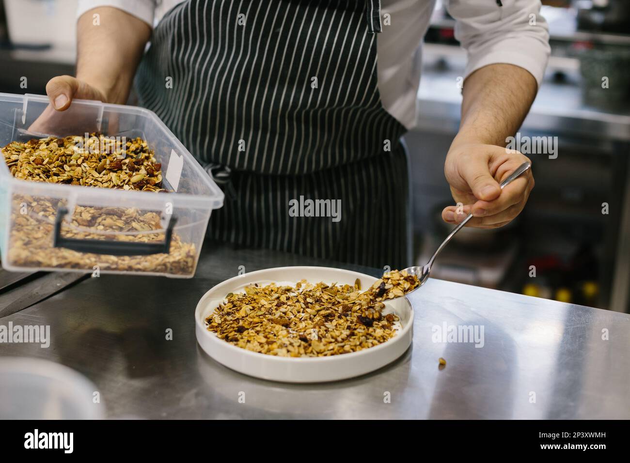 The process of making muesli in a restaurant, a male chef is working in