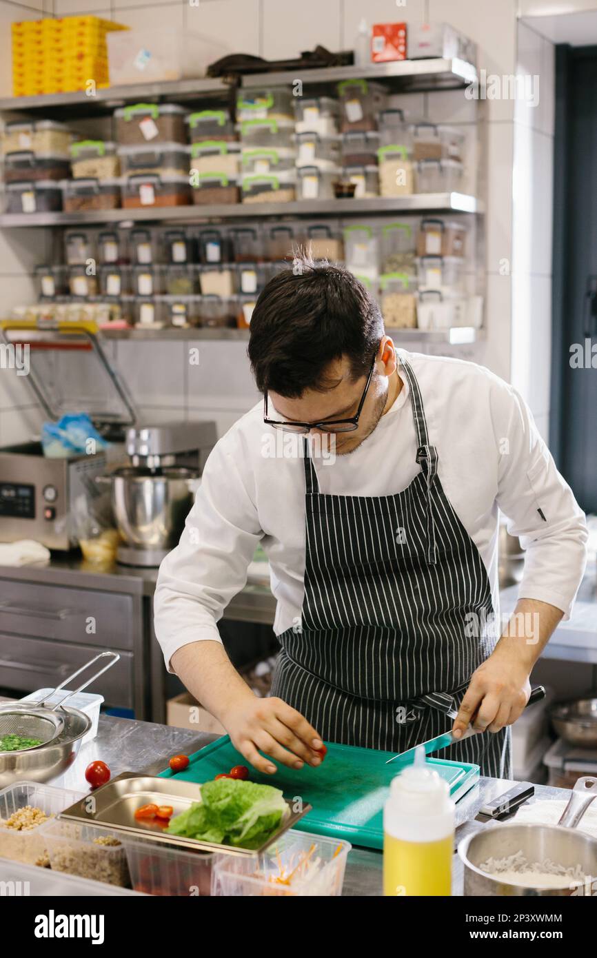 Gourmet bowl dish: precision cutting by a professional chef Stock Photo