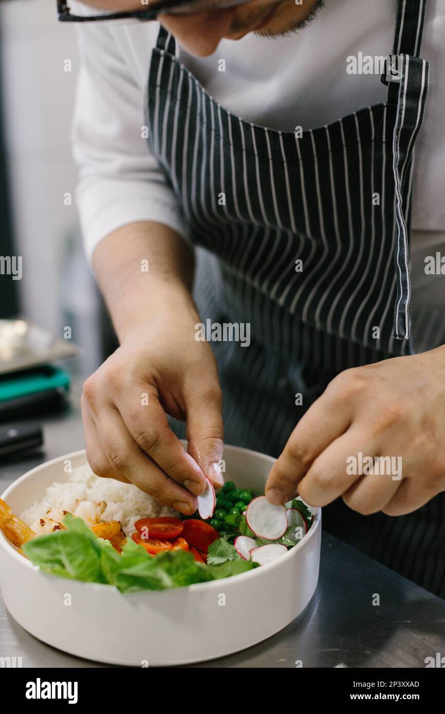Cropped view of chef preparing food, food, in kitchen, chef preparing food, chef decorating dish, close-up Stock Photo