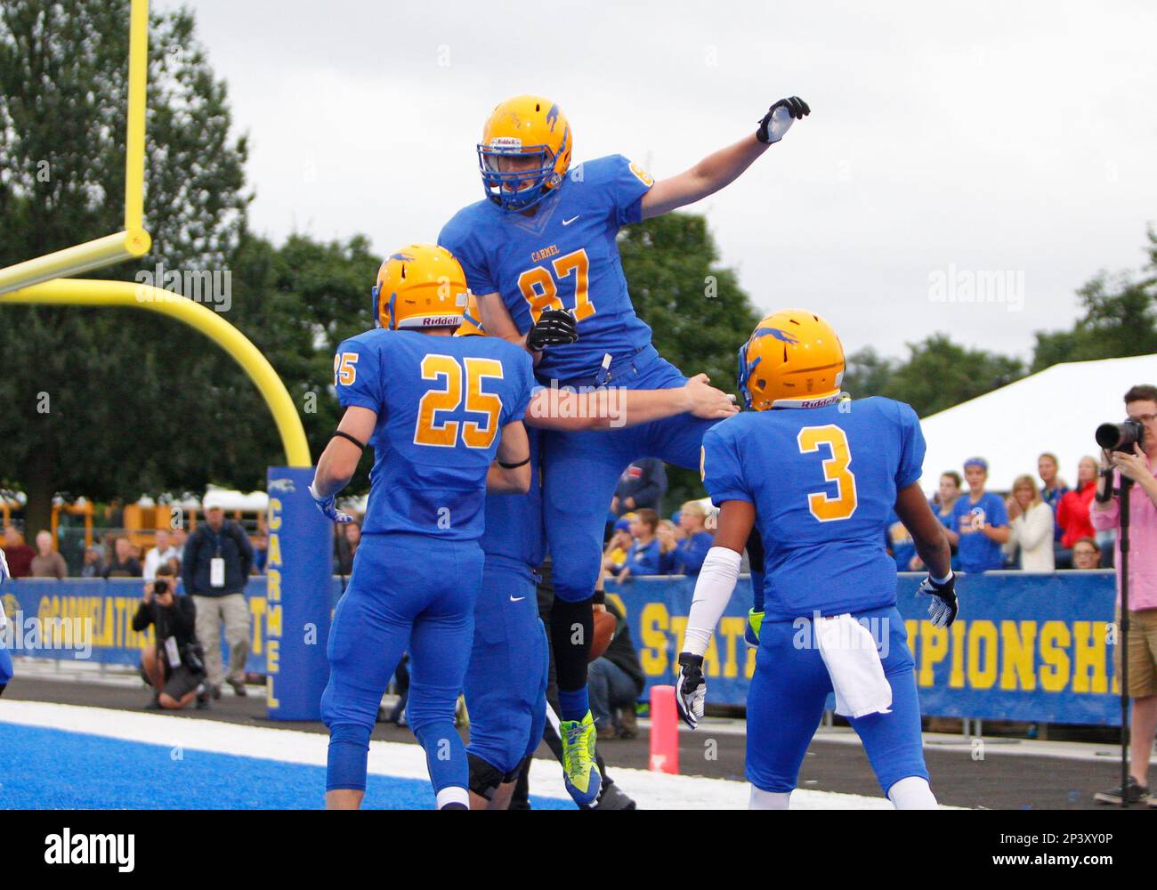 12 September 2014: Carmel tight end Jake Herr (87) is congratulated by his  teammates following a touchdown during the homecoming game between the  Carmel Greyhounds and the Pike Red Devils at Carmel