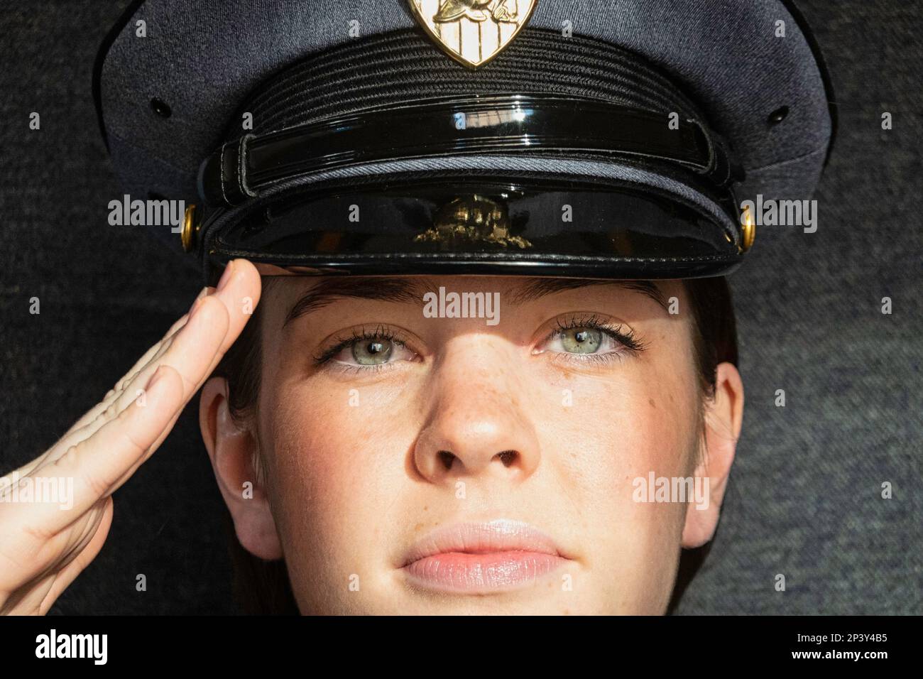 Close-up of a female West Point cadet, wearing her class a duty cap and saluting, USMA, 2023, USA Stock Photo