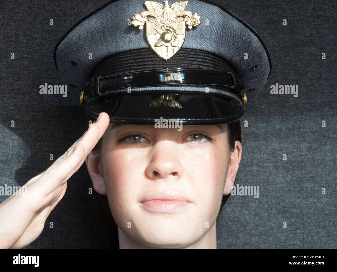 Close-up of a female West Point cadet, wearing her class a duty cap and saluting, USMA, 2023, USA Stock Photo