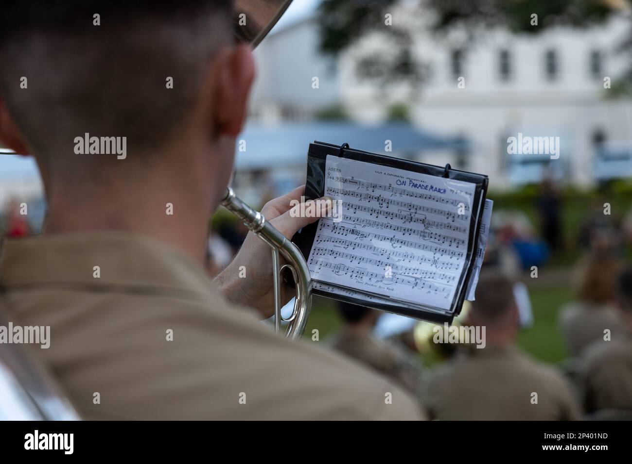 A U.S. Marine glances at sheet music while performing for attendees during a live concert for the local community at Plaza de Espana, Hagatna, Guam, Jan. 23, 2023. The MARFORPAC Band participated in multiple community engagements during their visit to Guam as part of the Naval Support Activity, Marine Corps Base Camp Blaz Reactivation and Naming Ceremony. In order to encourage music education and showcase the vibrant history and tradition of military music, the band is active in providing clinics and concerts for the communities they serve. The MARFORPAC Band performs throughout the Indo-Pacif Stock Photo