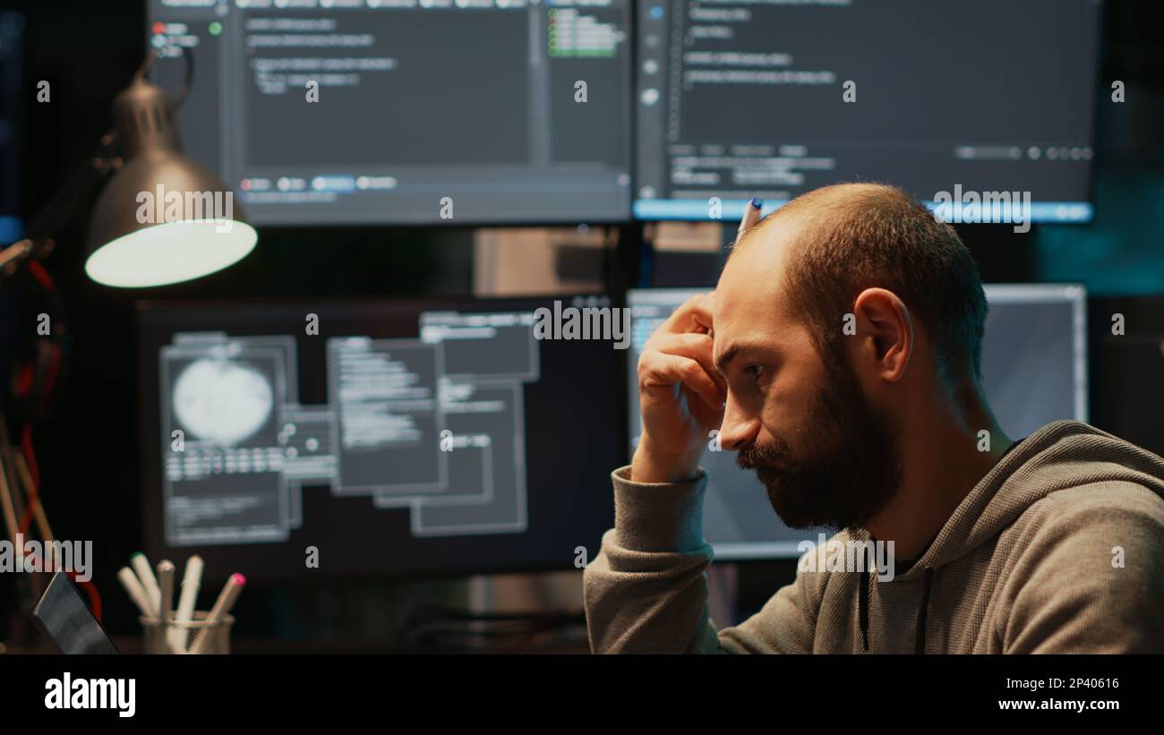 Thoughtful IT engineer brainstorming ideas in office, programming ...
