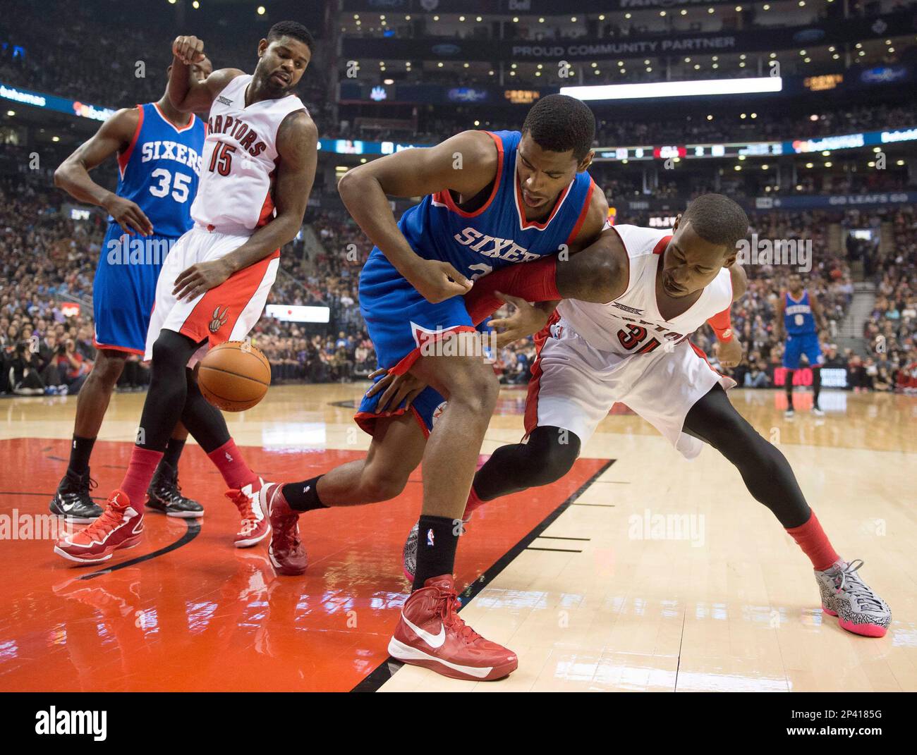 Toronto Raptors Terrence Ross, right, vies for the ball with Philadelphia 76ers Hollis Thompson as Raptors Amir Johnson (15) and 76ers Henry Sims (35) watch during the first half of an NBA