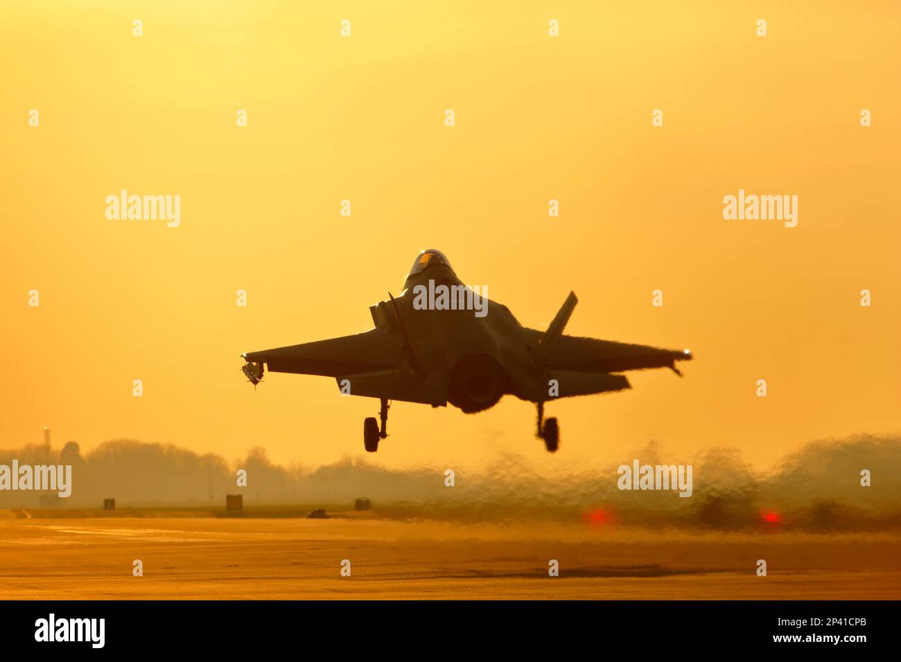 USAF Lockheed Martin F-35A Lightning II landing at sunset, RAF Lakenheath. Stock Photo