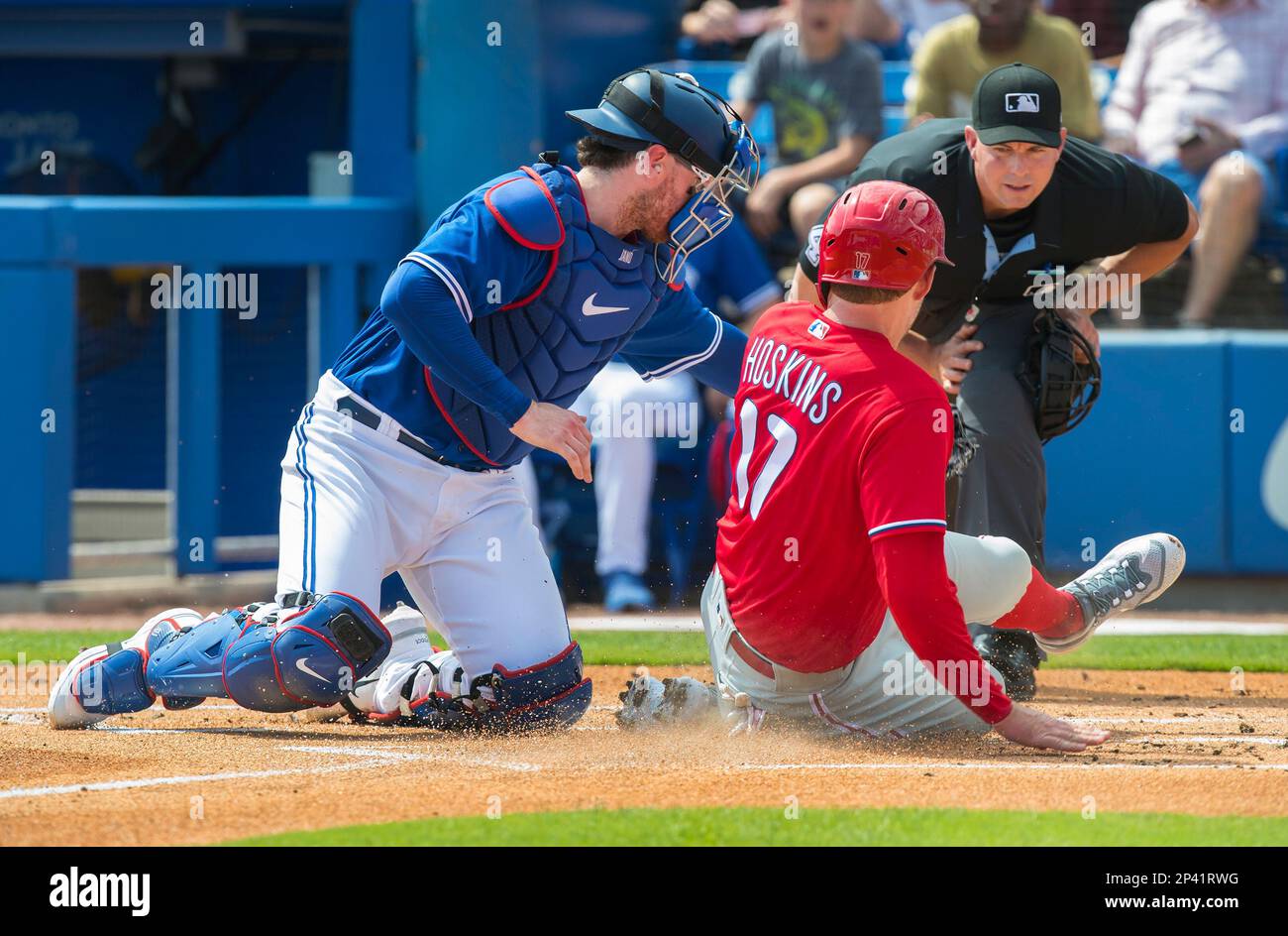 Philadelphia Phillies' Rhys Hoskins is out at home plate with the tag by  Toronto Blue Jays catcher Danny Jansen in the first inning of their spring  training game in Dunedin, Fla., Sunday