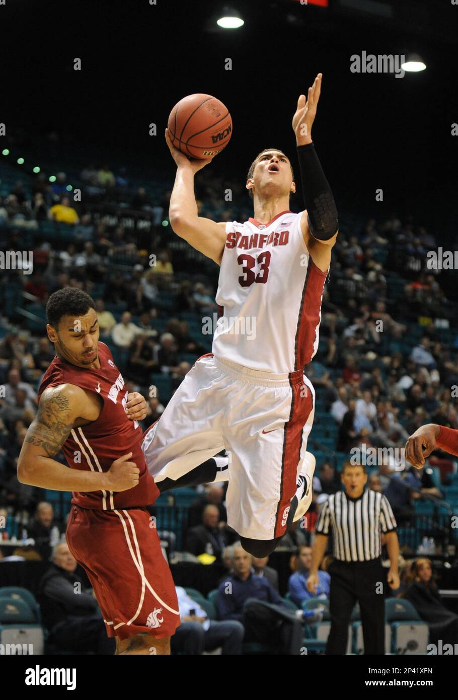 12 March 2014: Stanford (33) Dwight Powell fouls Washington State (25)  DaVonte Lacy during the men's Pac-12 basketball tournament game between the  Stanford Cardinal and the Washington State Cougars at the MGM