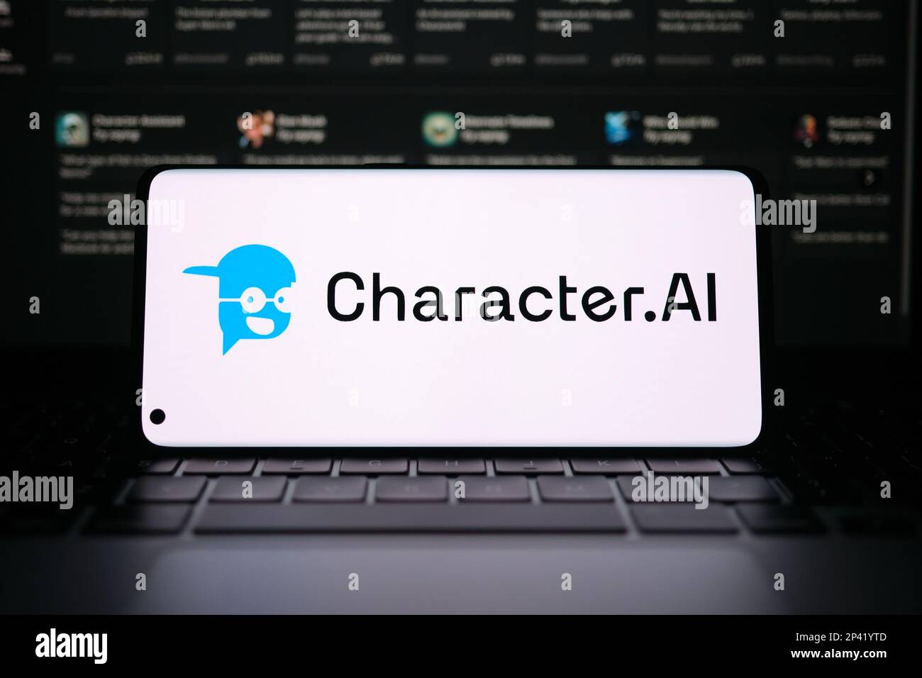 Character AI logotype seen on smartphone screen. Blurred Character.AI website on the background. Stafford, UK, March 5, 2023 Stock Photo