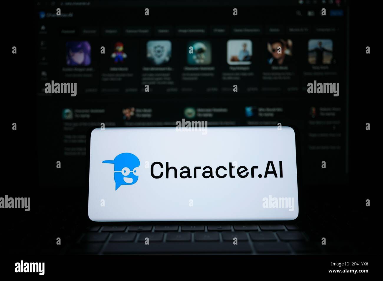 Character AI logotype seen on smartphone screen. Blurred Character.AI website on the background. Stafford, UK, March 5, 2023 Stock Photo