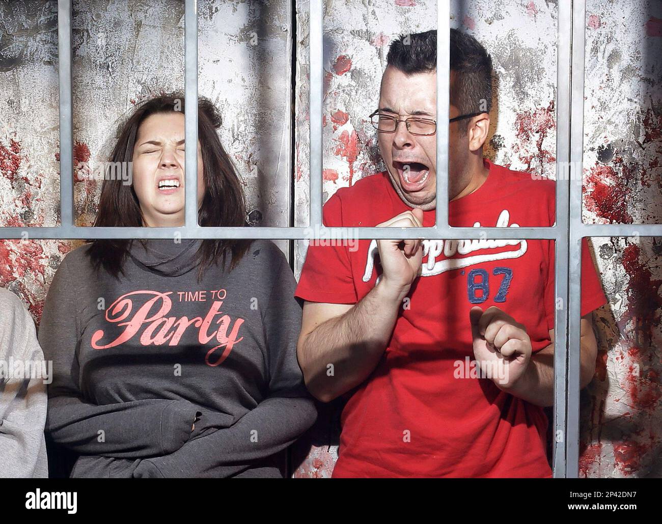 In this Oct. 27, 2014, photo, people react to a mock execution in the Gates of Hell haunted