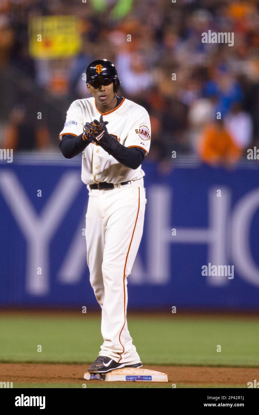 October 25, 2014: San Francisco Giants third baseman Joaquin Arias (13)  applauds after getting on second base in the 6th inning, during game 4 of  the World Series between the San Francisco, image size:866x1390