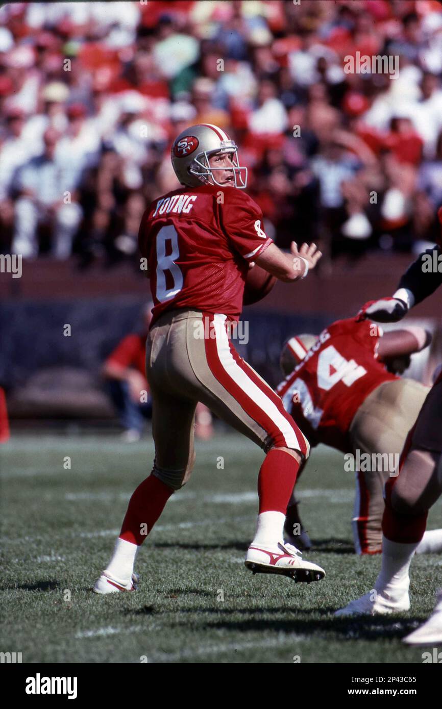 Steve Young #8 of the San Francisco 49ers drops back to pass.Circa