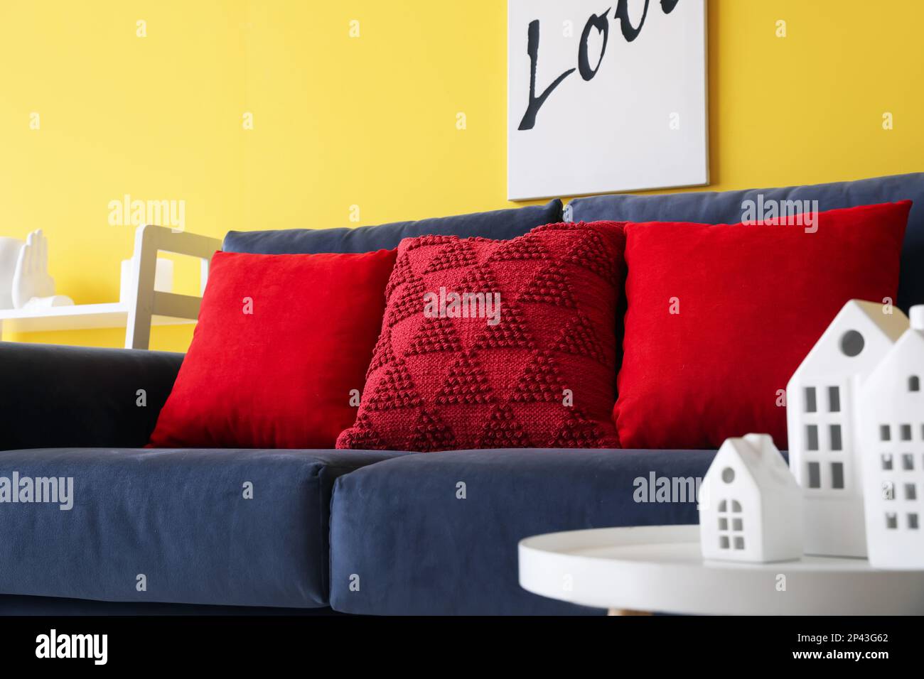 https://c8.alamy.com/comp/2P43G62/red-pillows-on-blue-sofa-in-living-room-closeup-2P43G62.jpg