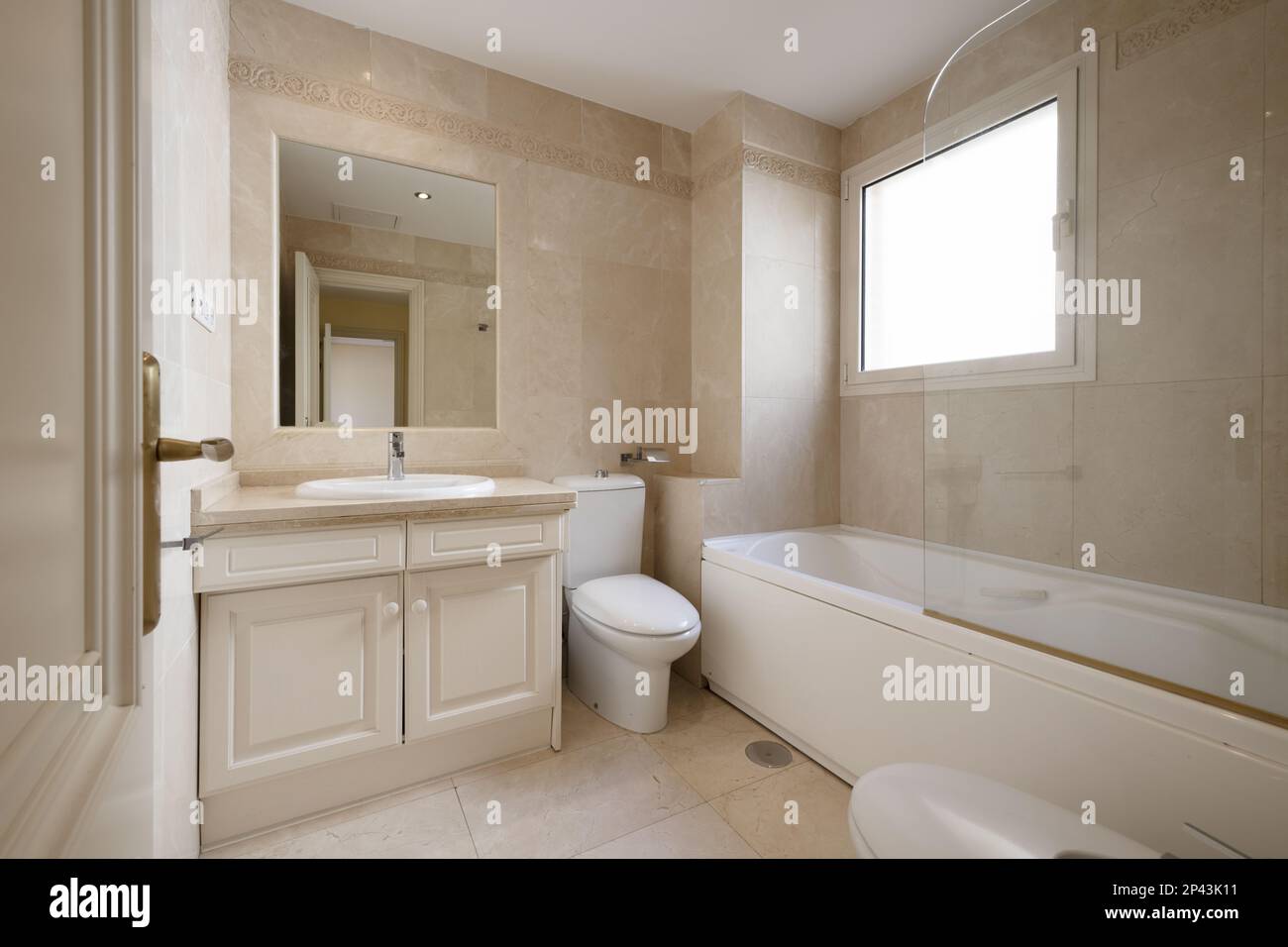 Bathroom with white hydromassage bathtub with glass partition, square