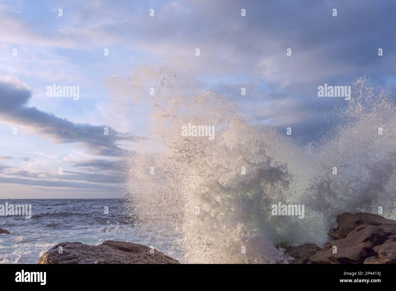 Waves hitting cliff on beach hi-res stock photography and images - Alamy