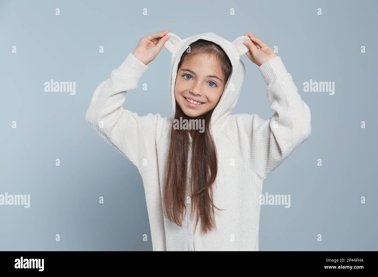 Cute girl in adorable white pajamas on light grey background Stock ...