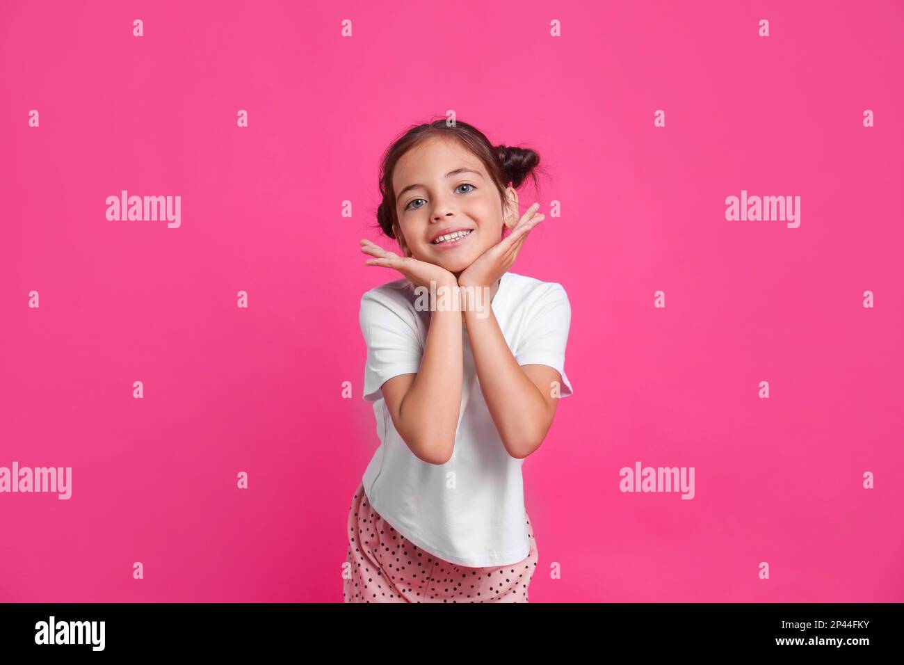 Cute girl in pajamas on pink background Stock Photo - Alamy