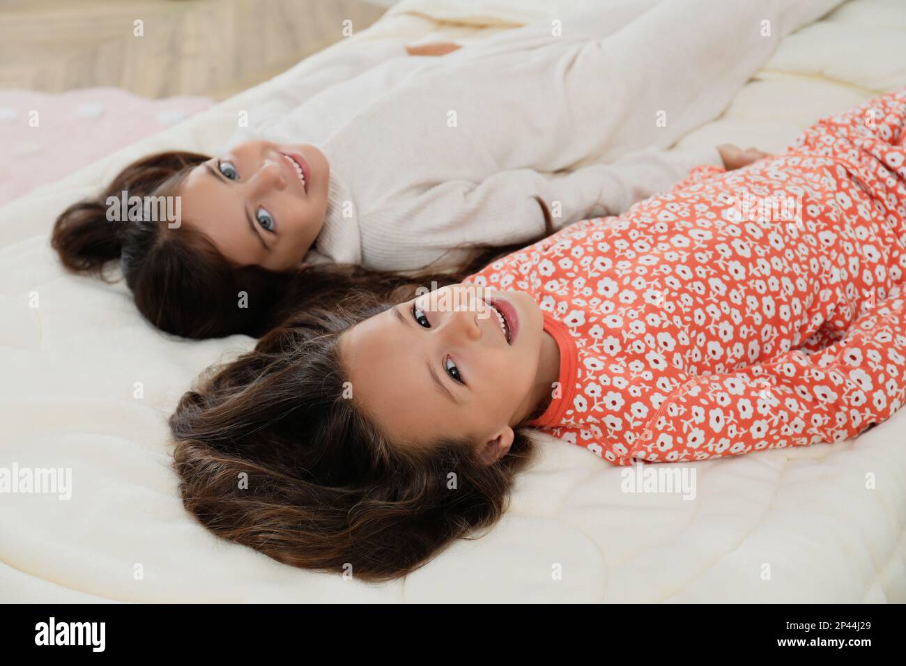 Cute girls in pajamas on bed at home Stock Photo Alamy