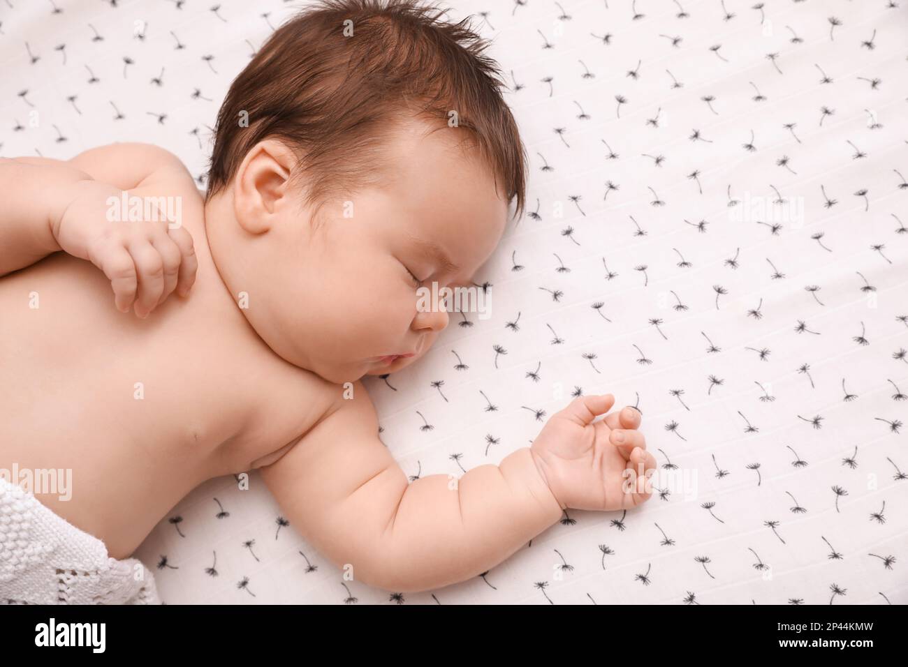 Cute little baby sleeping in crib at home, top view. Space for text