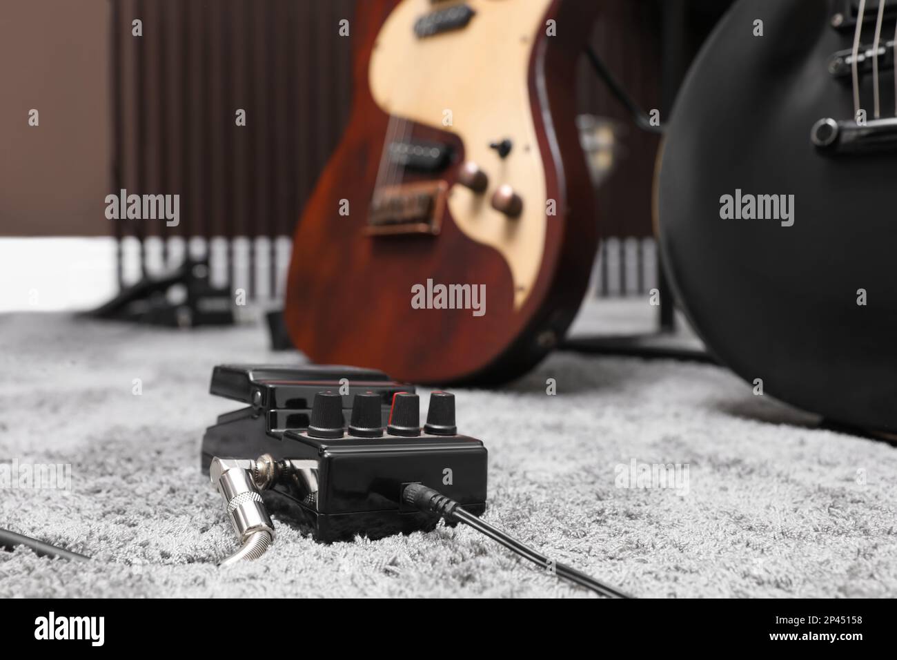 Electric guitar pedal at recording studio. Music band practice Stock