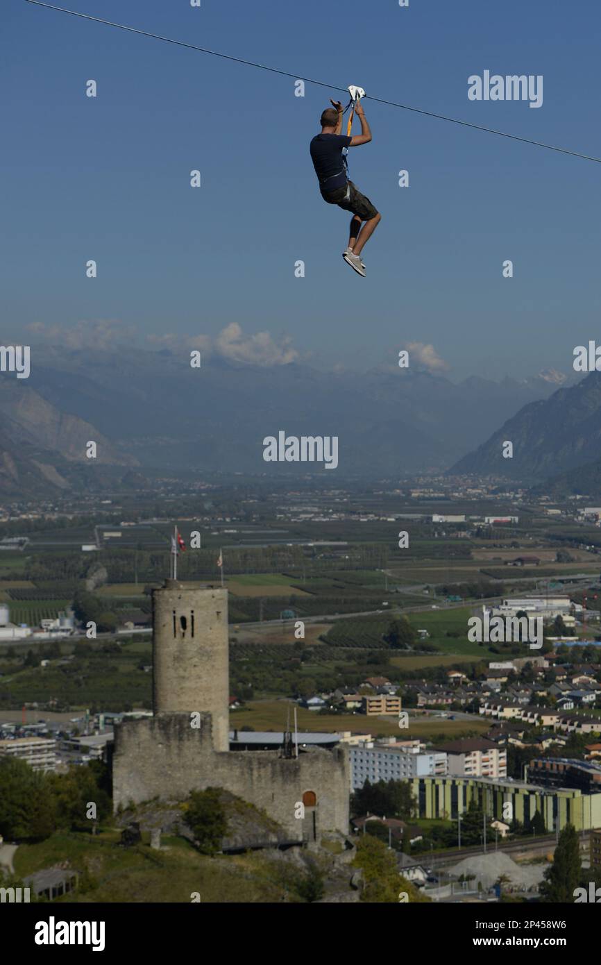 An unidentified man slips down the zip line before the opening of