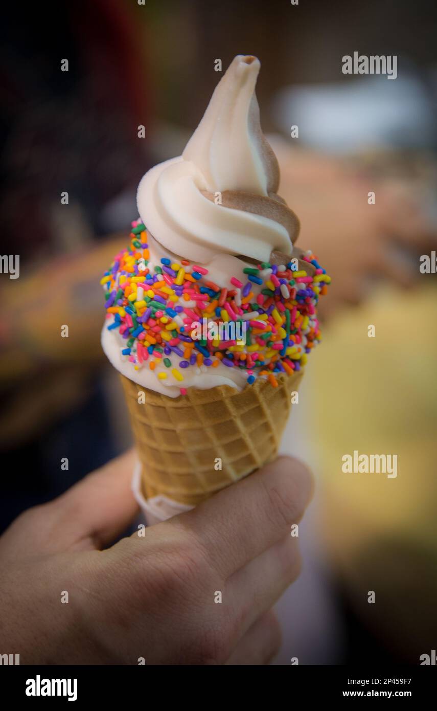 Chocolate Vanilla Swirl with Sprinkles about to be enjoyed Stock Photo