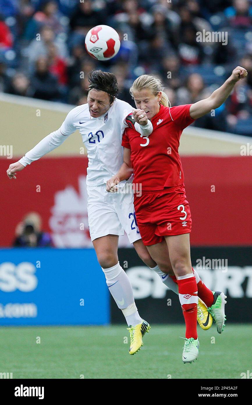 FILE - In this May 8, 2014, file photo, United States' forward Abby Wambach  (20) goes up for the header against Canada's defender Rebecca Quinn (3)  during first half of an exhibition