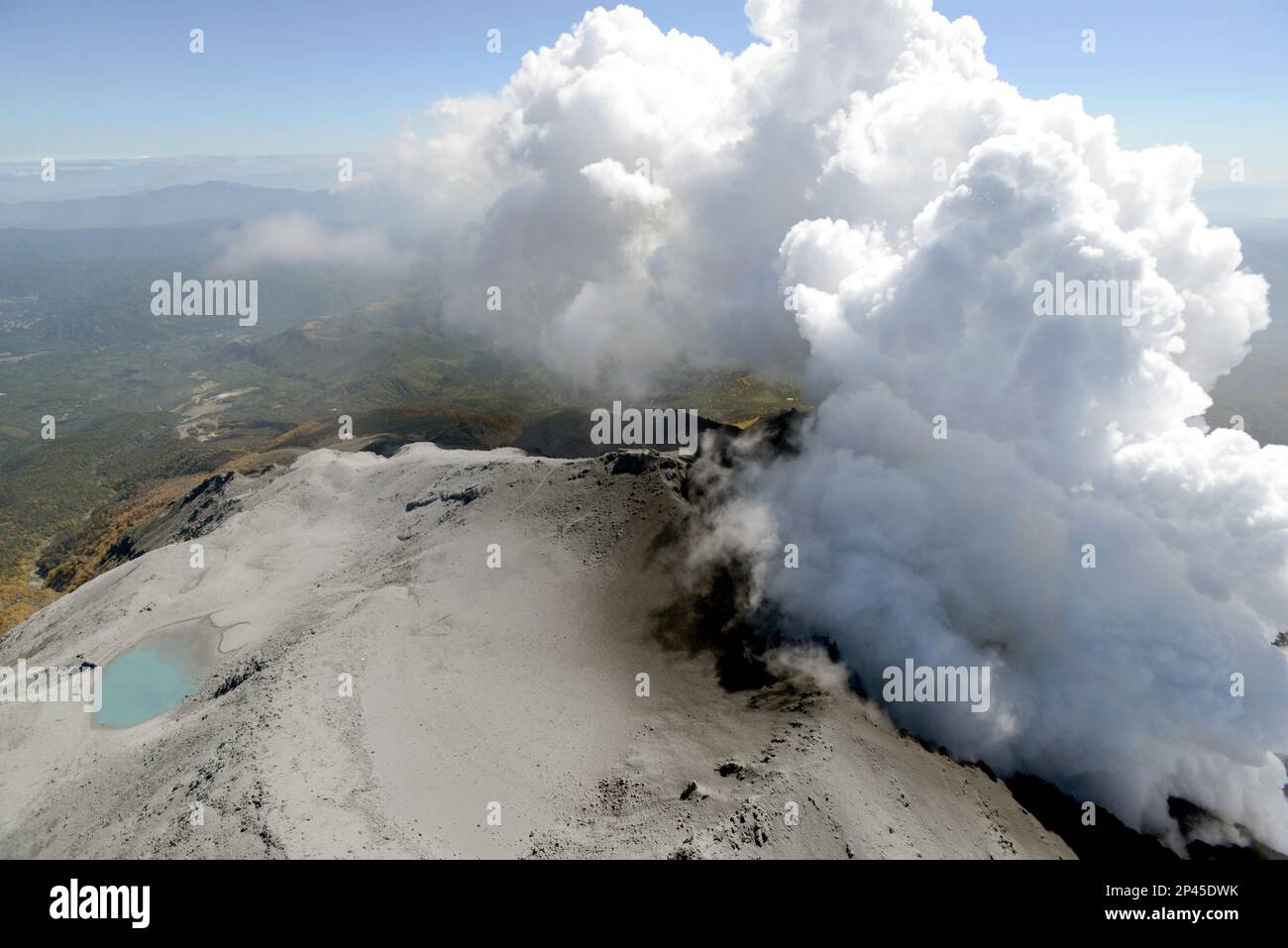 An aerial view shows volcanic smoke and fume raising from craters of