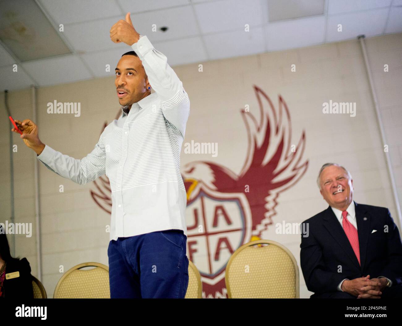 Rapper Ludacris, left, gives a thumbs up after taking a selfie while visiting the charter school Utopian Academy for the Arts with Georgia Gov. Nathan Deal, right, Friday, Sept. 26, 2014, in Riverdale, Ga. Deal and Ludacris may seem like an odd pairing for a campaign event, but the duo was a hit with a cheering crowd of students Friday. Christopher "Ludacris" Bridges has been an outspoken supporter of President Barack Obama, penning a profane song during the 2008 campaign criticizing his opponents. But Deal says he couldn't think of anyone better to inspire students at the event. (AP Photo/Dav Stock Photo