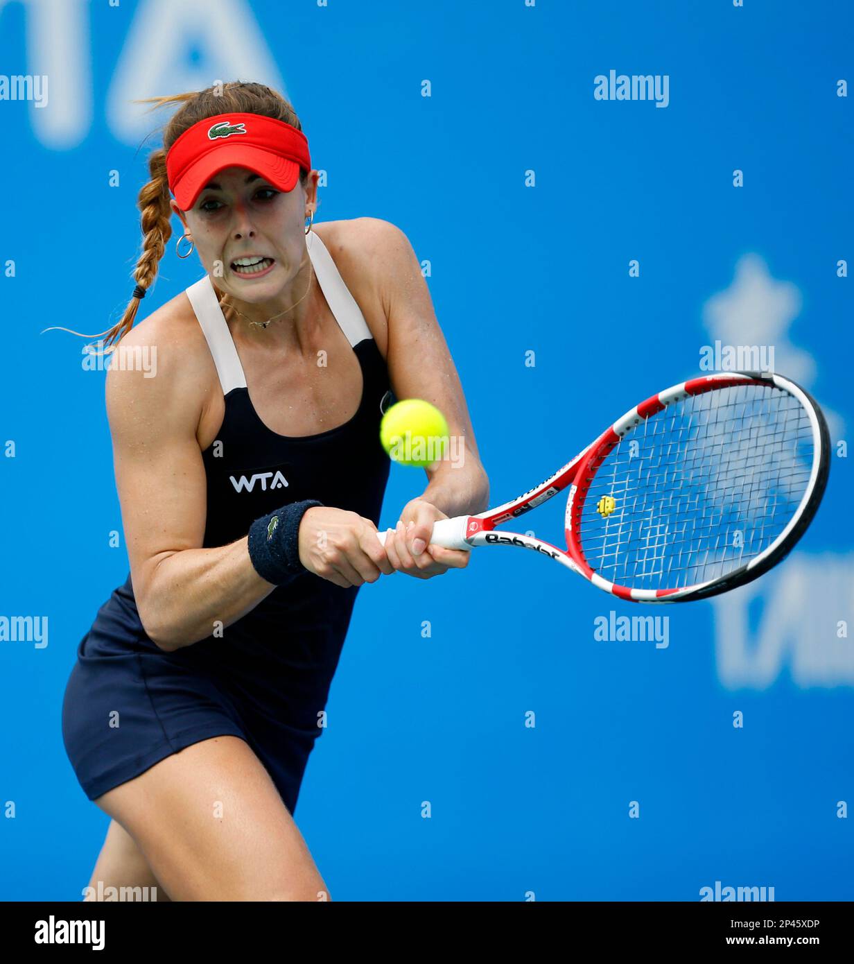 Alize Cornet of France returns a shot to Kirsten Flipkens of Belgium