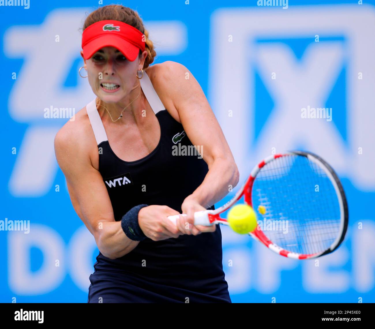 Alize Cornet of France returns a shot to Kirsten Flipkens of Belgium