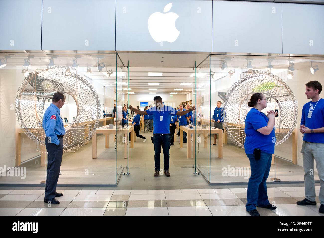 Apple store employees open the doors at 8 a.m. on the release date of the  new iPhone 6 at the Woodland Mall on Friday, Sept. 19, 2014 in Grand  Rapids, Mich. The